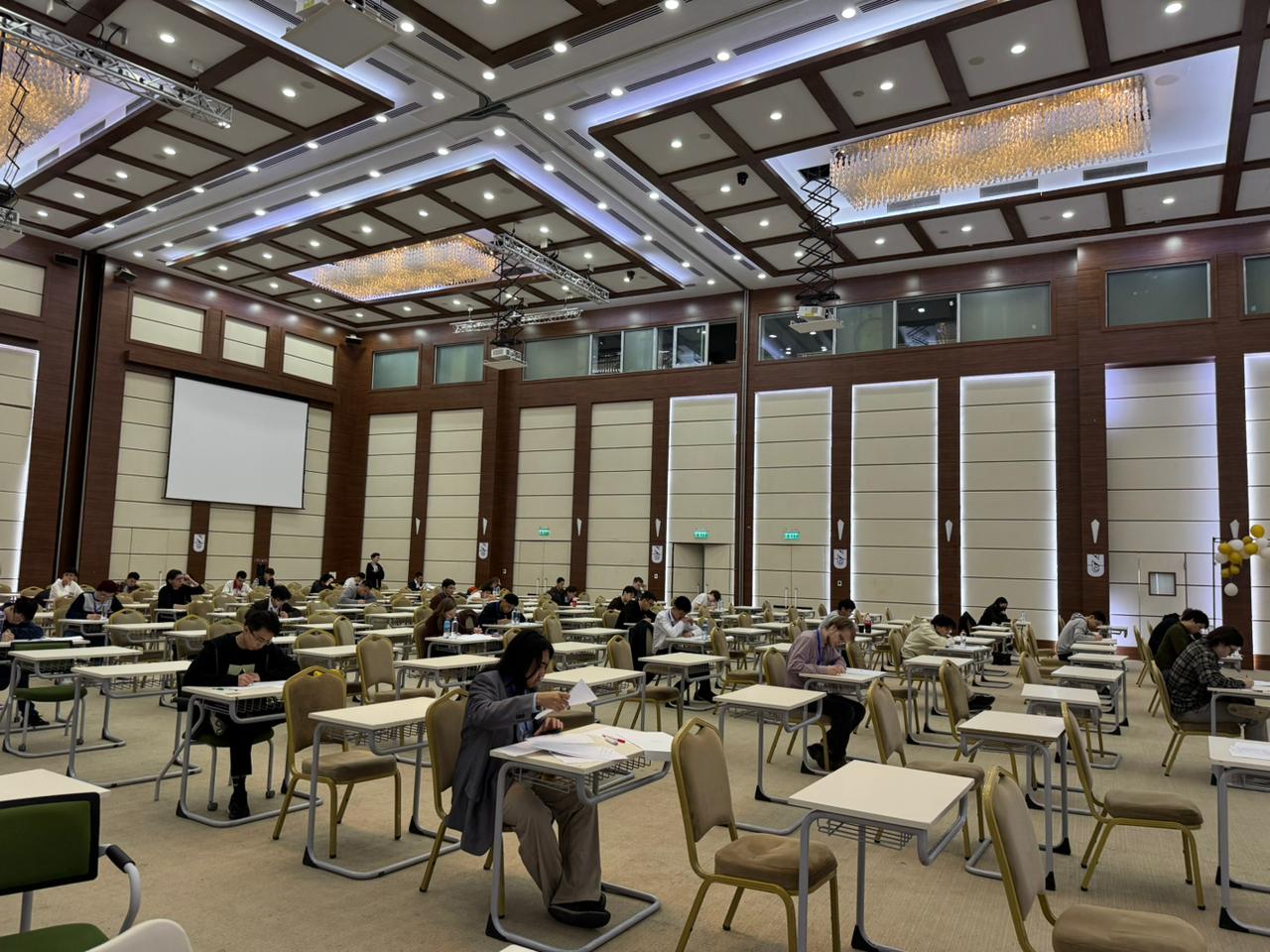 Participants working on problems during the first day of the Olympiad. alt text